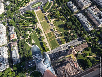 going-up-to-the-top-of-the-eiffel-tower-is-a-common-tourist-activity-but-the-daredevils-took-it-one-step-further-by-facing-dizzying-heights-to-dangle-off-of-the-legs-of-the-tower-and-snap-a-panoramic-s1
